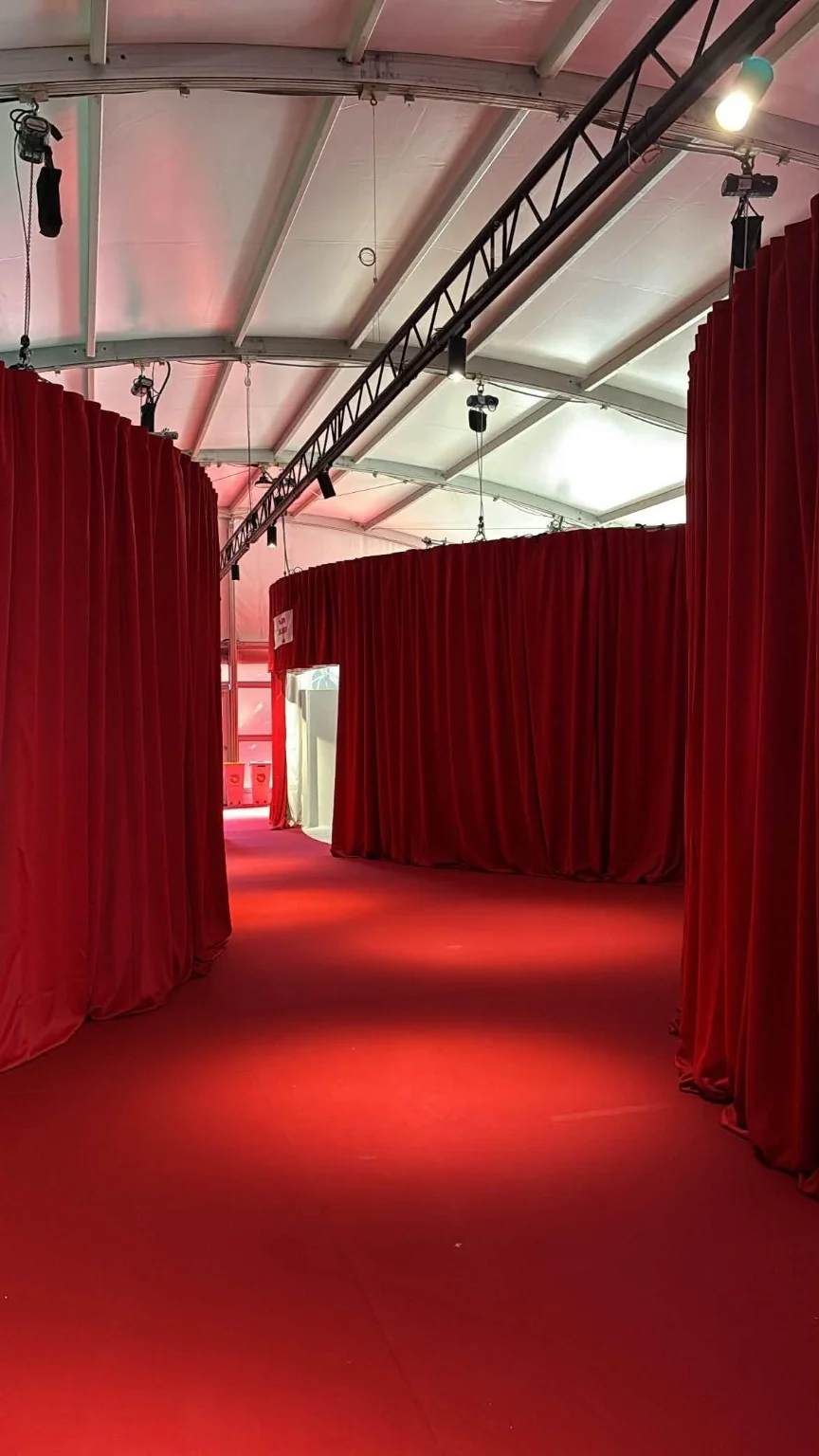 Red curtains along the JILL exhibition aisles