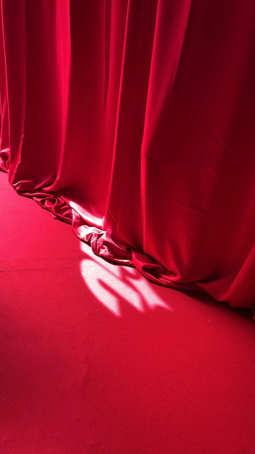 Light falling across the red exhibition floor