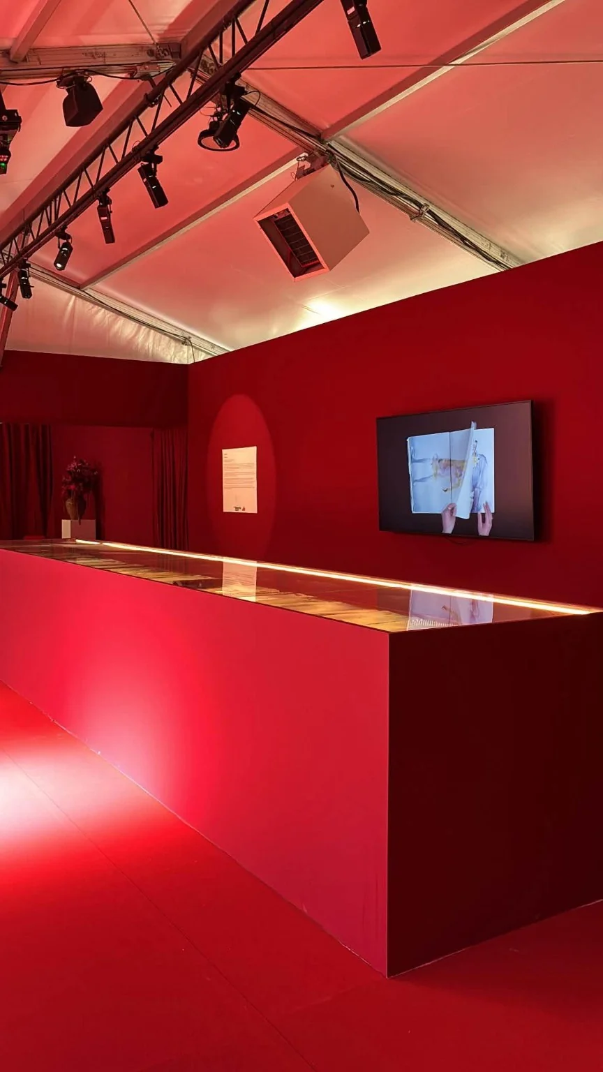 An illuminated display in the red exhibition space