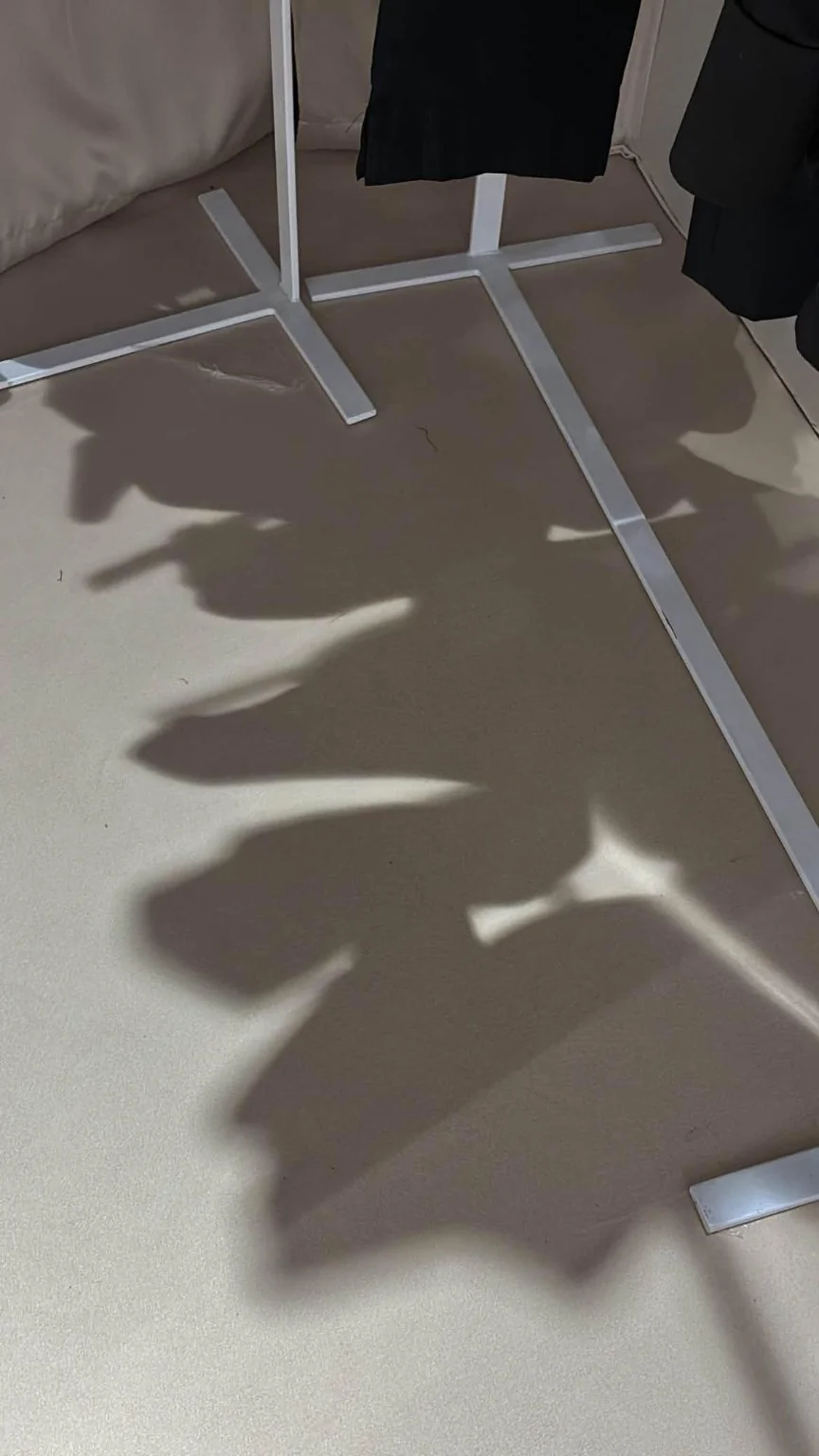 Shadows beneath the garment rails